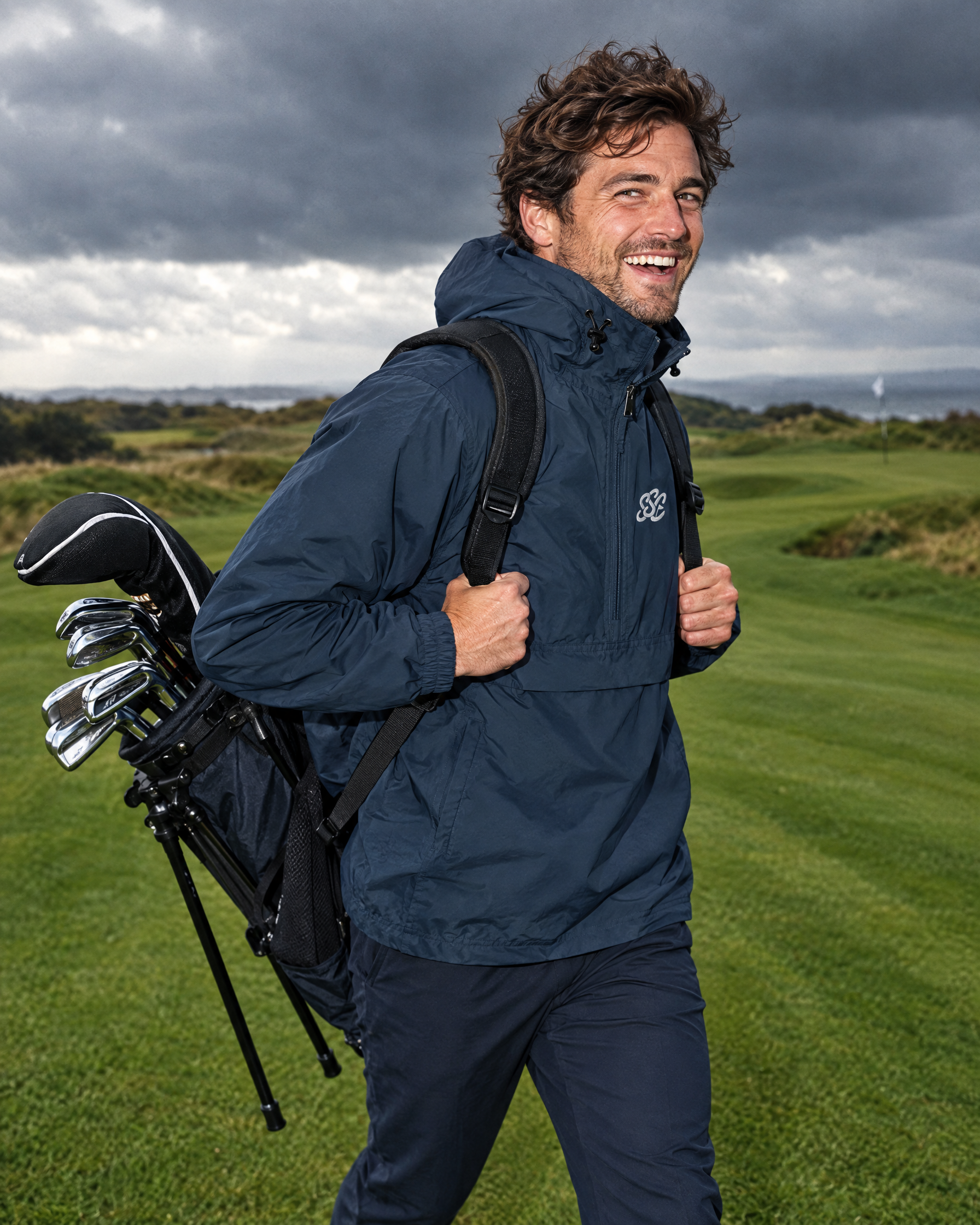 The Fairway Jacket in Navy walking the fairway on a windy day | Sunday Swing Club