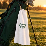 The Sunday Standard golf towel clipped to a golf bag on the fairway | Sunday Swing Club